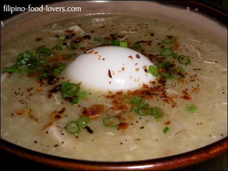 Arroz caldo in a bowl with egg, green onion and roasted garlic